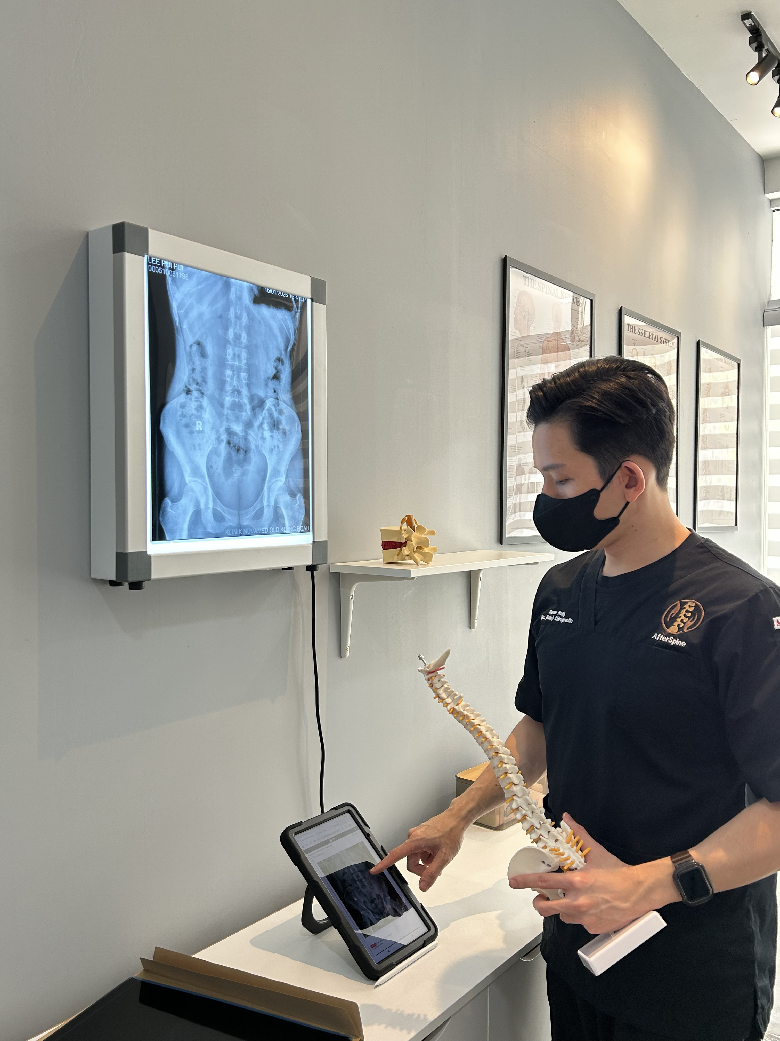 Dc Gene performing spinal consultation and assessment